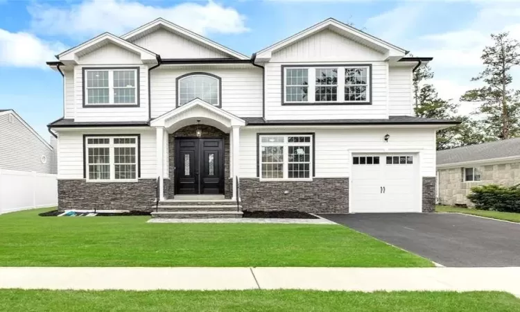 Craftsman-style home featuring a garage and a front yard