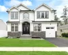 Craftsman house featuring a garage and a front lawn