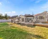 Back of property featuring a shed, a wooden deck, and a yard