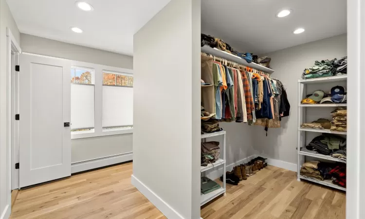 Walk in closet featuring a his and hers split