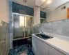 Full bathroom featuring toilet, combined bath / shower with glass door, tile patterned flooring, tile walls, and vanity