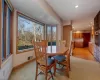 Carpeted dining space with plenty of natural light