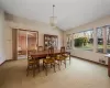 Dining room featuring vaulted ceiling and light carpet