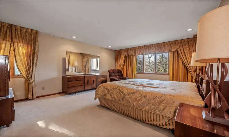 Bedroom featuring light carpet