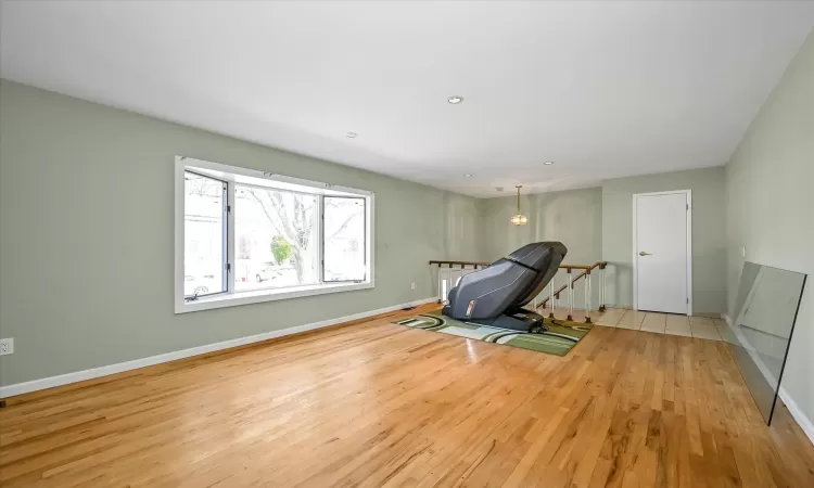 Workout room featuring light wood-type flooring