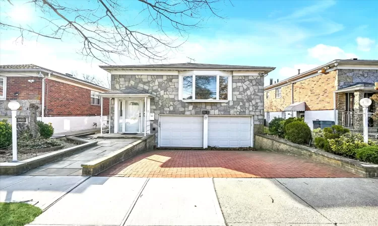 View of front facade featuring a garage