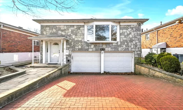 View of front facade featuring a garage