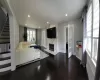 Living room featuring dark hardwood / wood-style flooring, a fireplace, and ornamental molding