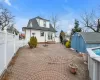 Rear view of property featuring a storage shed and a patio