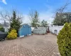 View of patio / terrace featuring a fenced in pool, a storage shed, and area for grilling