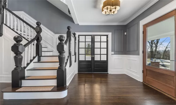 Front foyer with restored hardwood floors, oak banisters and railings.