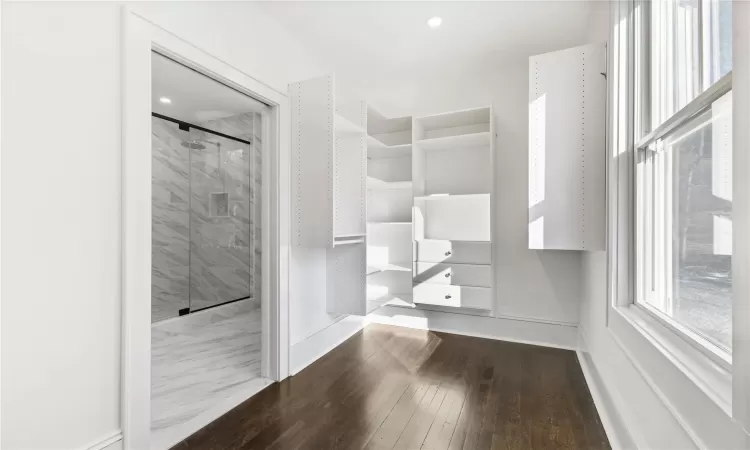 Primary bedroom  featuring crown molding and hardwood flooring.