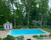 View of pool featuring a patio area and an outbuilding