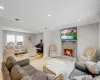 Living room with a brick fireplace and a baseboard heating unit