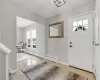 Entryway featuring a baseboard radiator, a wealth of natural light, and light tile patterned floors