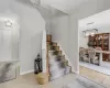 Staircase with tile patterned floors and a notable chandelier