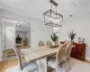 Dining area with light hardwood / wood-style flooring and a notable chandelier