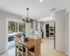 Dining room featuring sink, a notable chandelier, and light tile patterned floors