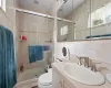 Bathroom with toilet, tile walls, decorative backsplash, vanity, and a shower with door