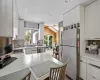 Kitchen with tasteful backsplash, white cabinets, sink, kitchen peninsula, and stainless steel appliances