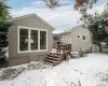 Snow covered house featuring a deck