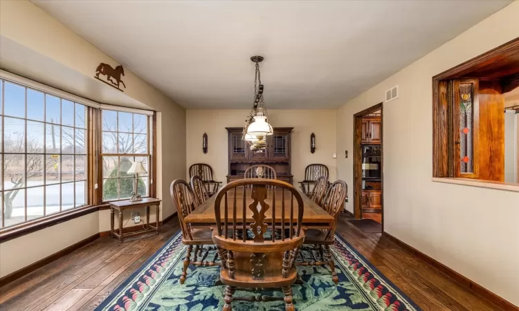 Dining space featuring dark wood-type flooring