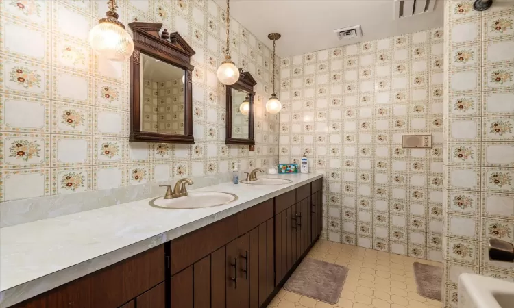 Bathroom featuring tile patterned floors and vanity