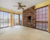 Unfurnished living room with ceiling fan and carpet