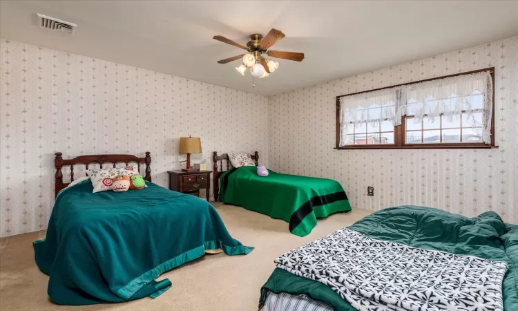 Bedroom with ceiling fan and carpet floors