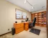 Carpeted office space featuring track lighting