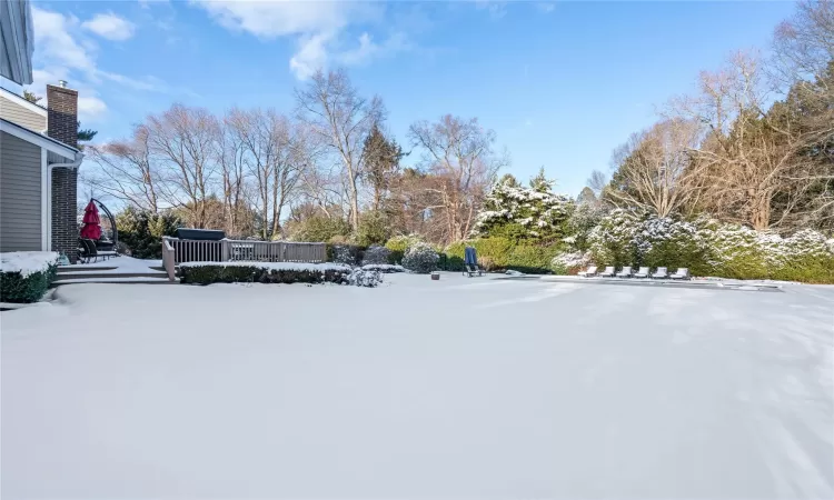 Snowy yard with a deck