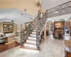 Stairs featuring a high ceiling, tile patterned floors, and an inviting chandelier