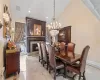 Dining space with an inviting chandelier and a large fireplace