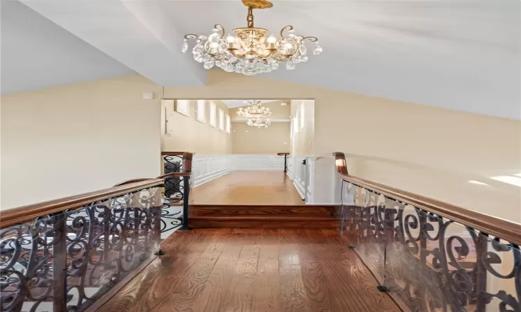 Corridor featuring a chandelier and hardwood / wood-style flooring