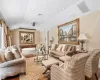 Living room with hardwood / wood-style floors and lofted ceiling