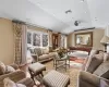 Living room with billiards, vaulted ceiling, a wealth of natural light, and hardwood / wood-style floors