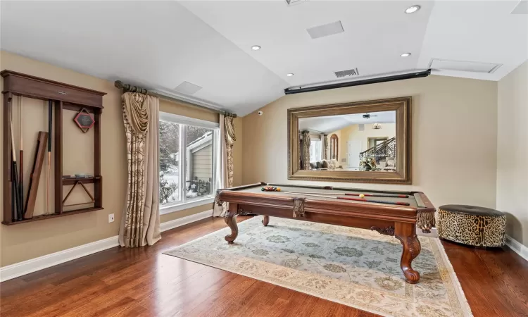 Rec room featuring dark wood-type flooring, pool table, and vaulted ceiling