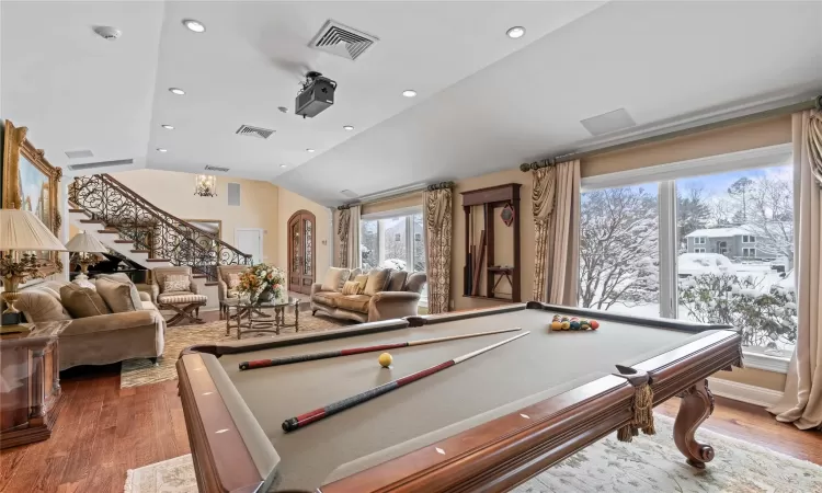 Rec room with billiards, wood-type flooring, and vaulted ceiling