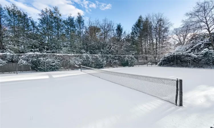 View of community featuring tennis court