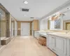 Bathroom with tile patterned flooring, an enclosed shower, and vanity