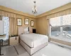 Bedroom with carpet floors and a notable chandelier