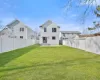 Rear view of house with a lawn