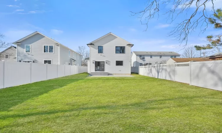 Rear view of house with a lawn