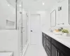 Bathroom featuring vanity, walk in shower, and ornamental molding