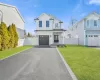 Modern farmhouse featuring a garage and a front yard