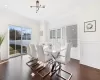 Dining area with crown molding, an inviting chandelier, and dark hardwood / wood-style flooring