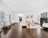 Living room with a high end fireplace, crown molding, and dark hardwood / wood-style floors