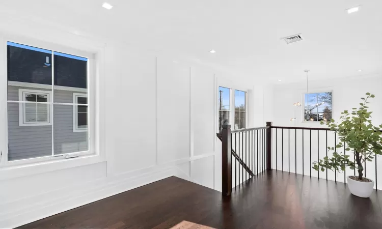 Corridor with crown molding and dark hardwood / wood-style flooring