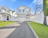 View of front of property with a front yard and a garage