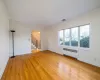 Empty room featuring radiator heating unit, ornamental molding, and light hardwood / wood-style floors